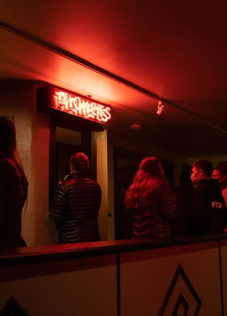 a group of people standing in front of a red light